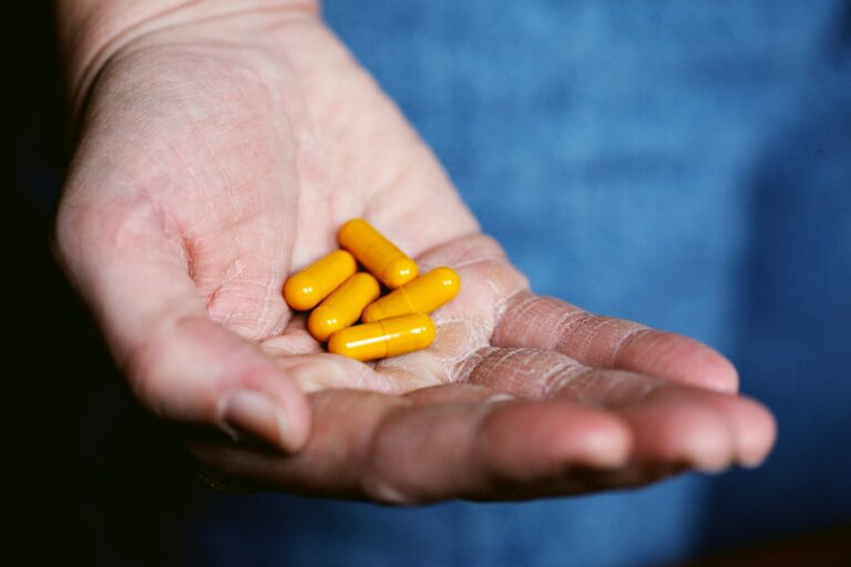 yellow medication pill on persons hand,Cardiovascular Supplements