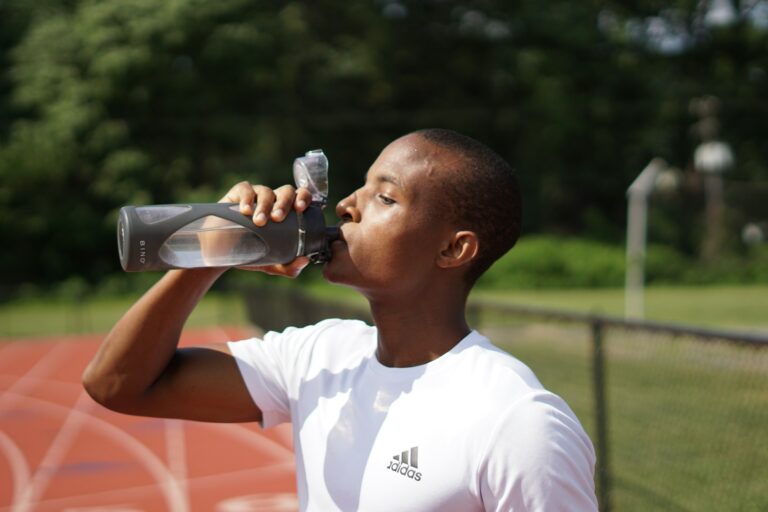 Person drinking water after exercise