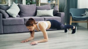 a woman is doing Push-ups at home for cardiovascular fitness