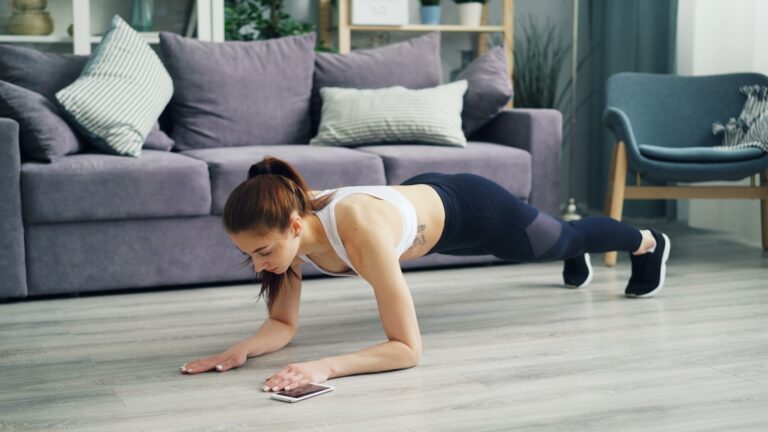 a woman is doing Push-ups at home for cardiovascular fitness