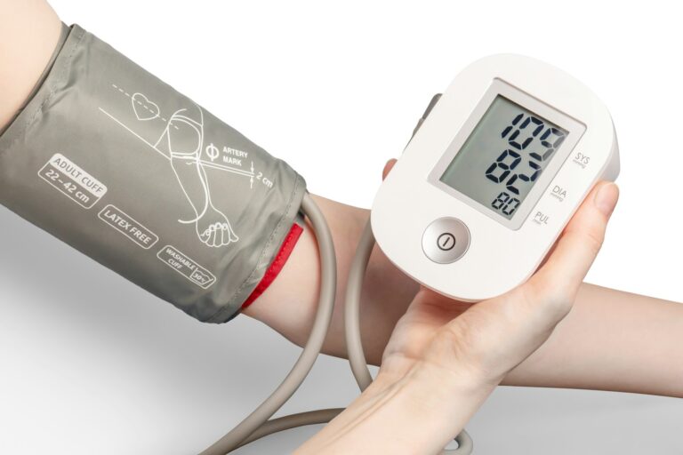Person using a digital blood pressure monitor at home
