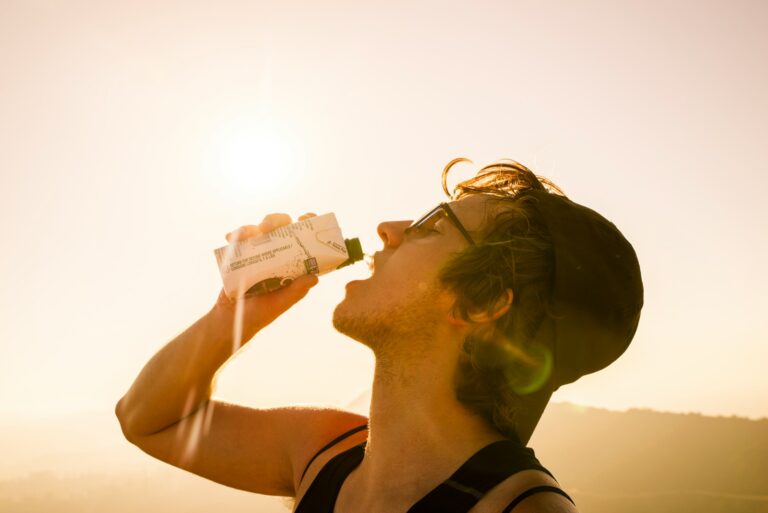 Person drinking from reusable water bottle